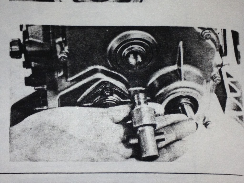 The manual shows the manual starter boss being unscrewed from the camshaft.