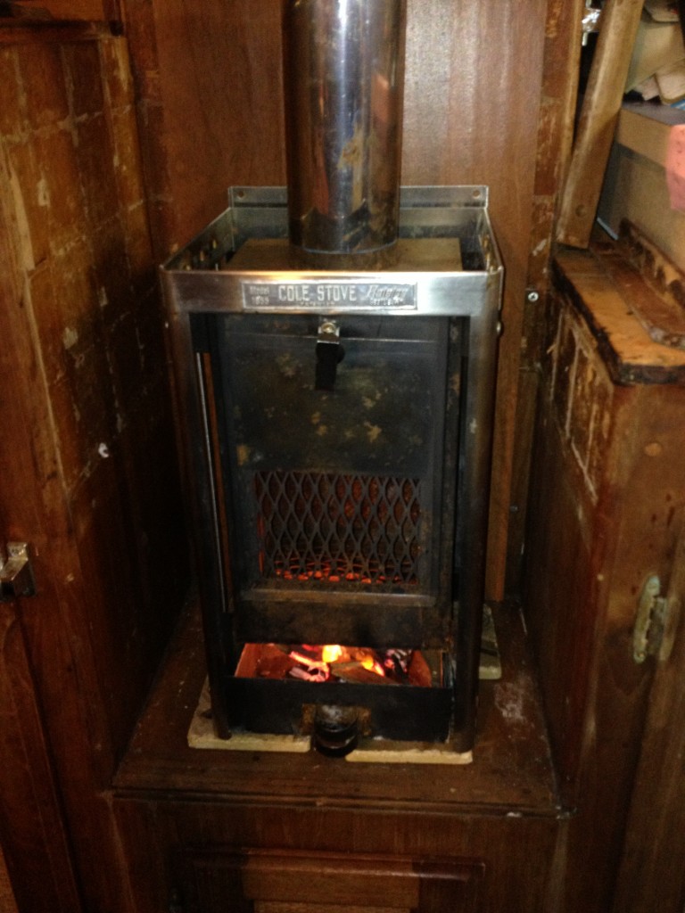 The first fire was built in the ash tray.  it's supposed to go up higher in the firebox.  Coasters underneath are to keep the boat from burning down during this test.